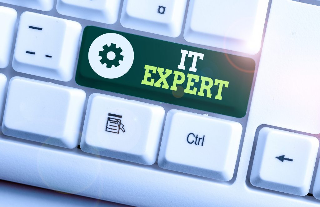 Writing note showing It Expert. Business photo showcasing demonstrating with high level of knowledge in information technology White pc keyboard with note paper above the white background.