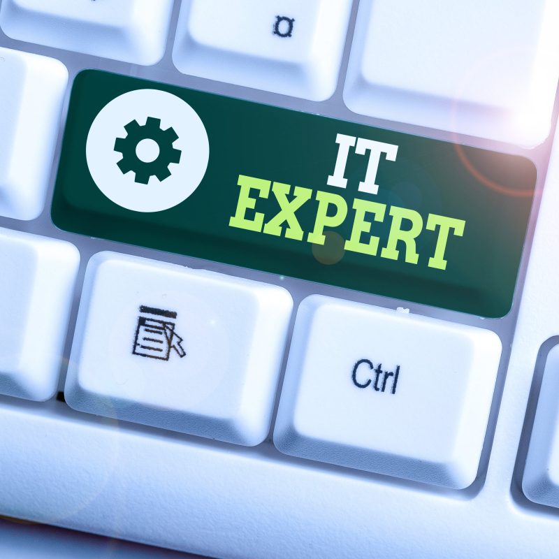 Writing note showing It Expert. Business photo showcasing demonstrating with high level of knowledge in information technology White pc keyboard with note paper above the white background.